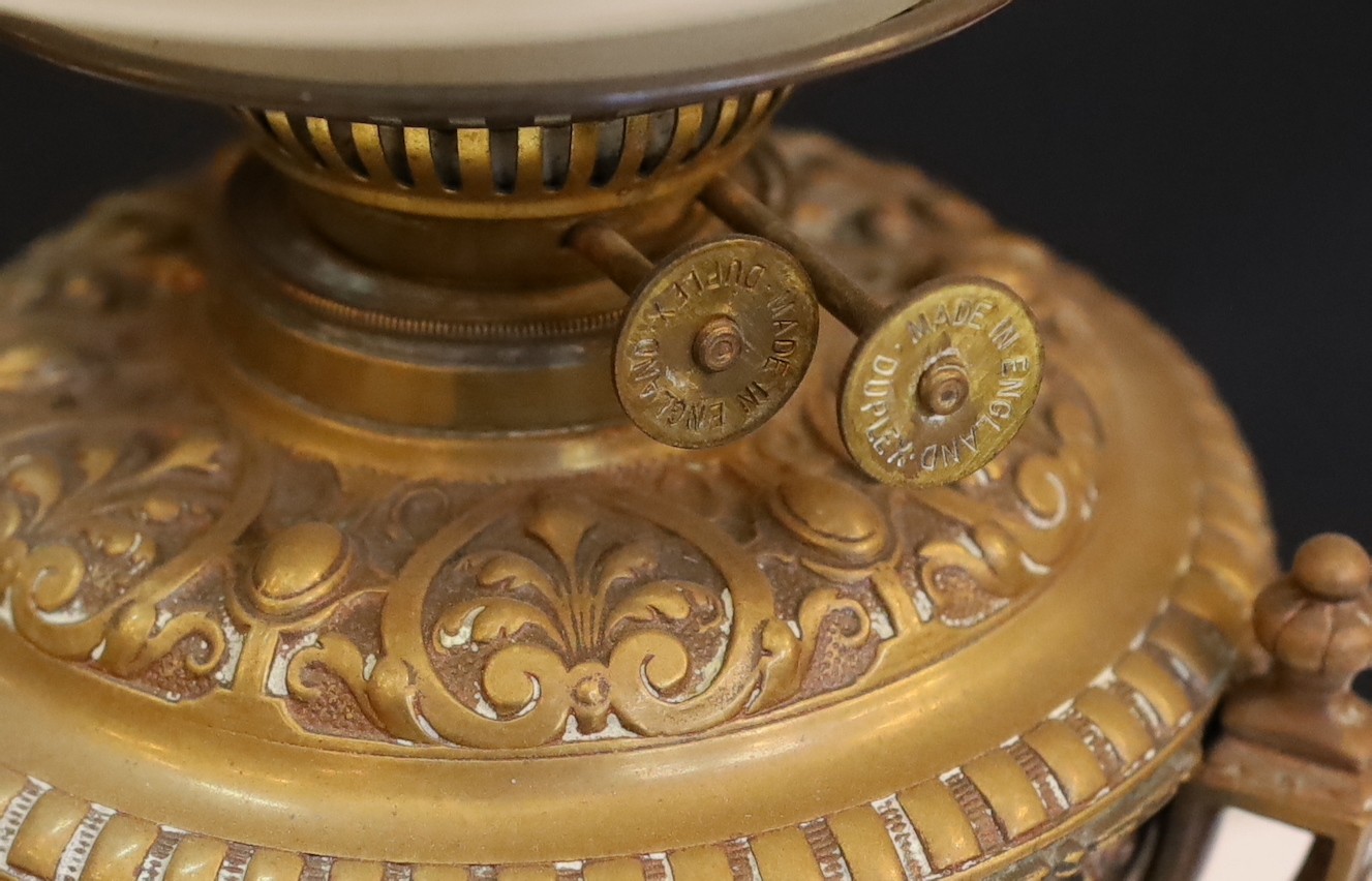 A Victorian bronze Renaissance revival oil lamp, decorated with masks and scrolls, with duplex mechanism, frosted glass shade and flue, height overall 58cm